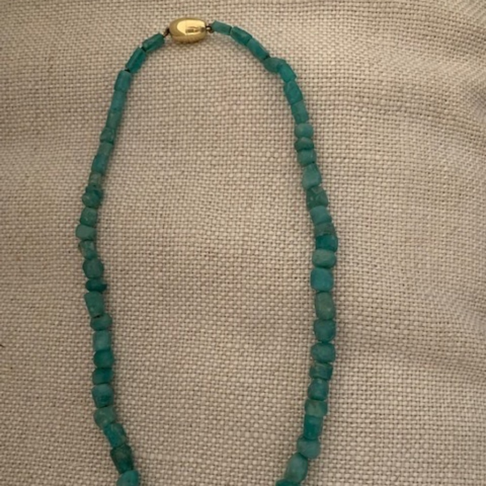 Raw emerald with golden closure